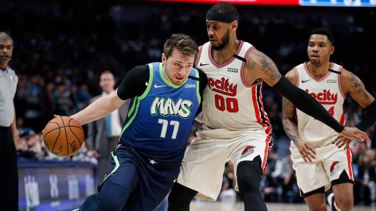 Dallas Mavericks forward Luka Doncic (77) drives as Portland Trail Blazers forward Carmelo Anthony (00) defends during the first half of an NBA basketball game Friday, Jan. 17, 2020, in Dallas. (AP Photo/Brandon Wade)