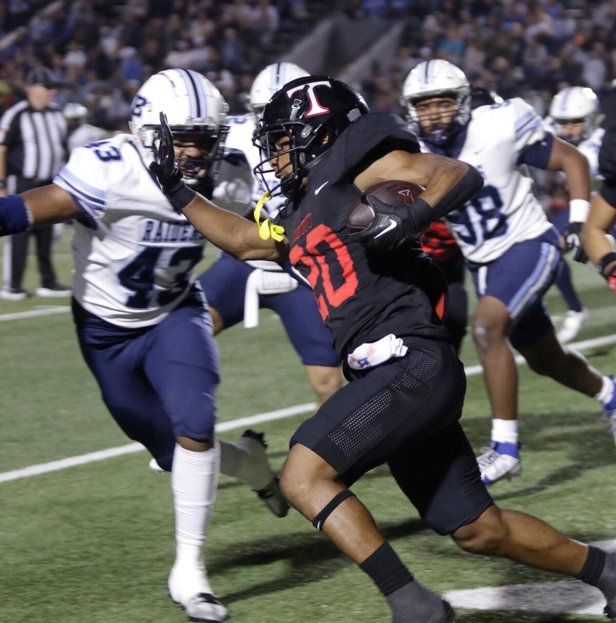 Trinity’s Josh Bell tries to get to the outside of L.D. Bell’s defense during a UIL football game at Pennington Field on Friday November 7, 2024.