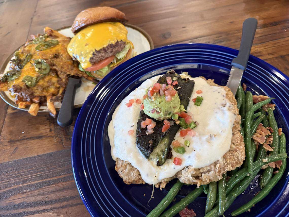 A chicken-fried steak with a grilled poblano, guacamole and pico de gallo on top, and a Fred Burger with chili-cheese fries at the new Fred’s Texas Cafe location in Crowley, Texas, Jan. 22, 2026.