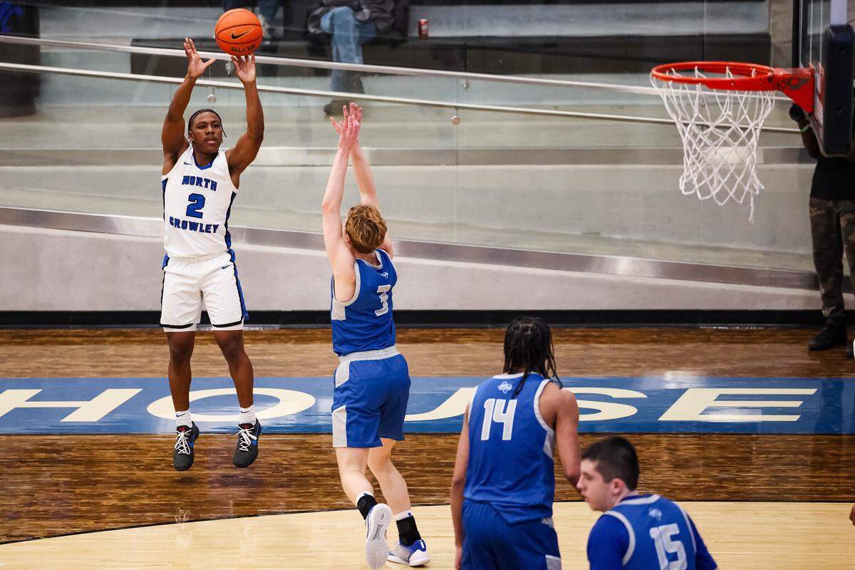 North Crowley guard Kameron Price (2) attempts a 3-pointer over a Weatherford defender in a District 3-6A matchup against Weatherford on Friday at North Crowley.
