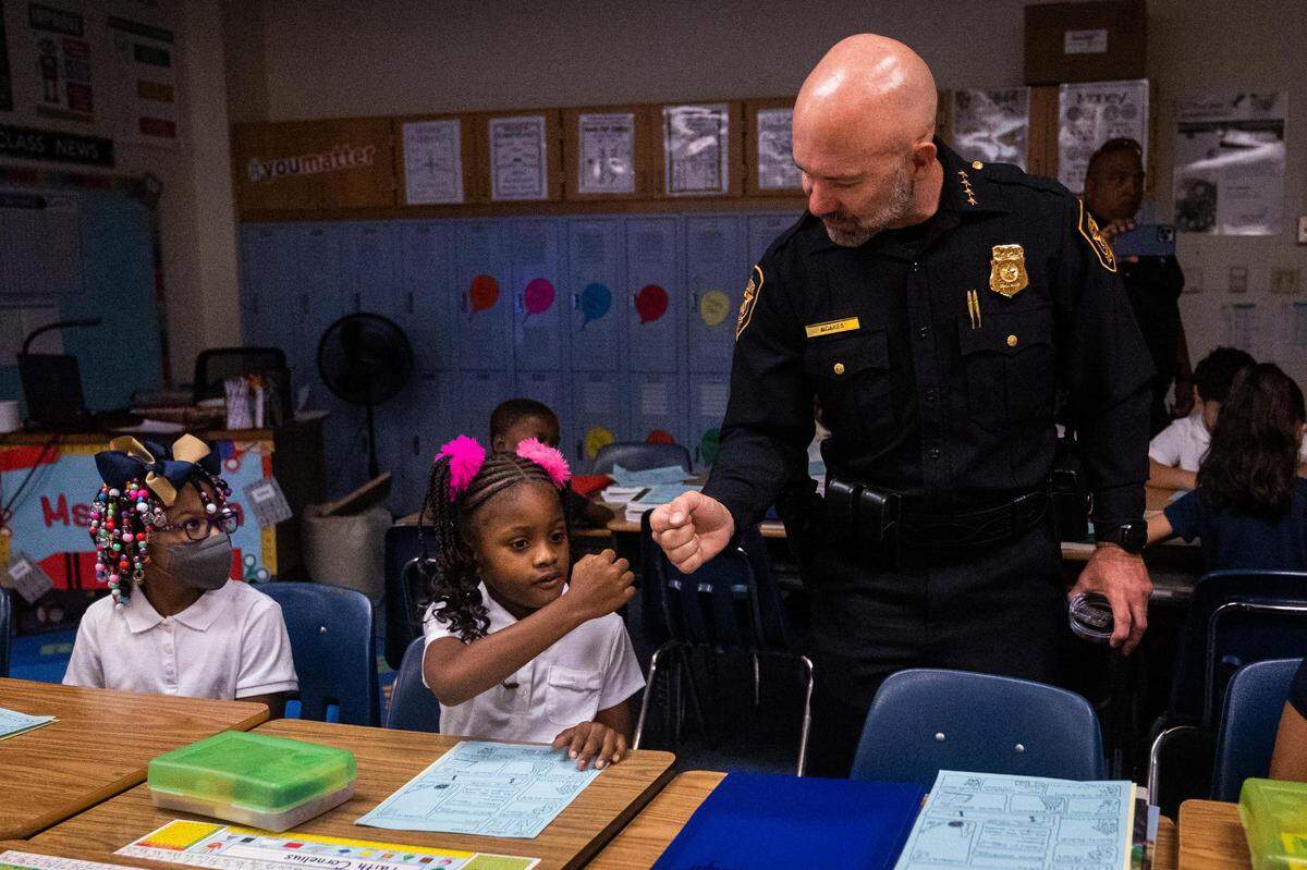 Chief Neil Noakes fist bumps Faith Cornelius as classes commence on the first day of school on Aug. 15, 2022, at Clifford Davis Elementary School in Fort Worth.