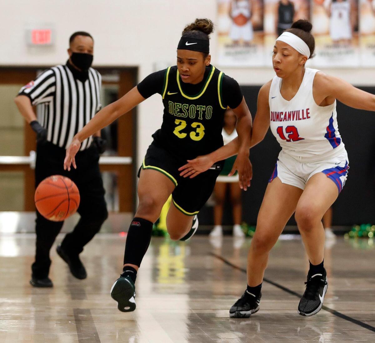 DeSoto guard Kendall Brown (23) brings the ball down court pursued by Duncanville point Zaria Rufus (12) during the first half of the 6A Region II Regional Final basketball game at Waxahachie High School in Waxahachie, Texas, Tuesday, March 02, 2021. DeSoto led 24-19 at the half. (Special to the Star-Telegram Bob Booth)