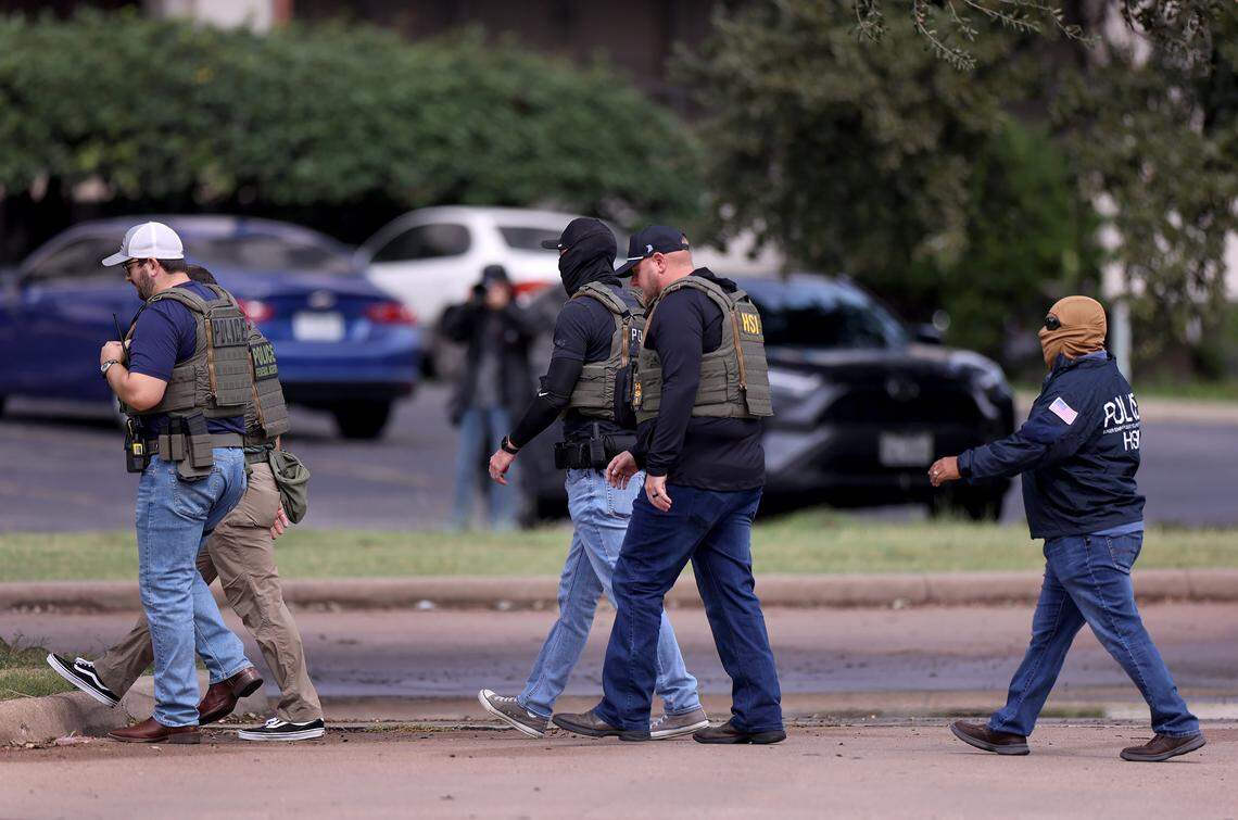 Law enforcement investigate the scene where a shooting at an Immigration and Customs Enforcement facility occurred in Dallas on Wednesday, Sept. 24, 2025.