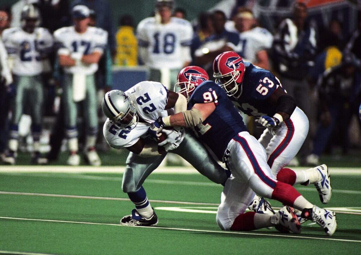 Jan 30, 1994; Atlanta, GA, USA; FILE PHOTO; Buffalo Bills nose tackle Jeff Wright (91) tackles Dallas Cowboys running back Emmitt Smith (22) during Super Bowl XXVIII at the Georgia Dome. Dallas defeated Buffalo 30-13. Mandatory Credit: RVR Photos-USA TODAY Sports