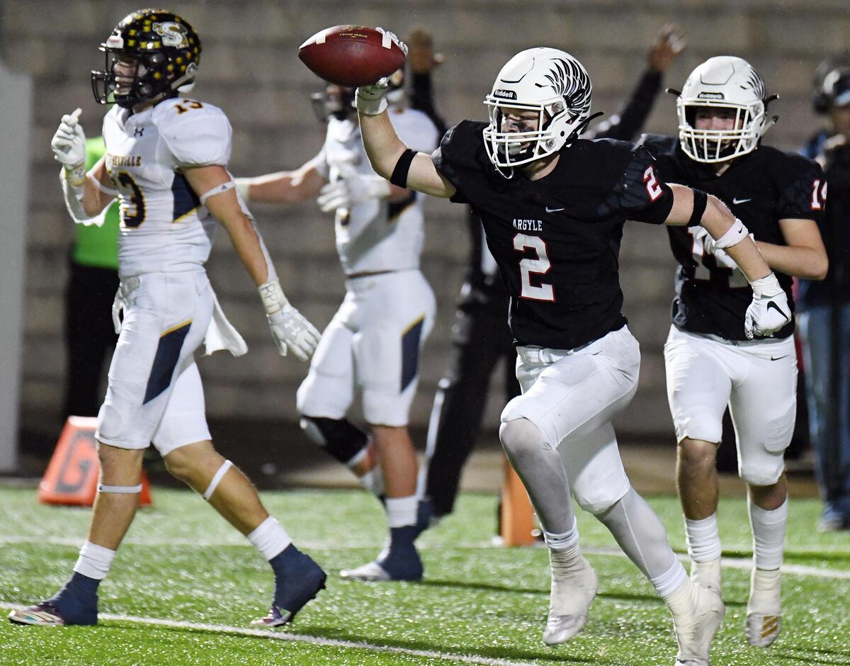 Argyle’s Jake Sullivan, center, celebrates as he runs off the field after interceping a Stephenville pass stopping the Yellowjacket’s last drive of the game in the fourth quarter of an area playoff football game at Vernon Newsom Stadium in Mansfield, Texas on Thursday, November 21, 2019. Argyle won 63-49. Special/Bob Haynes