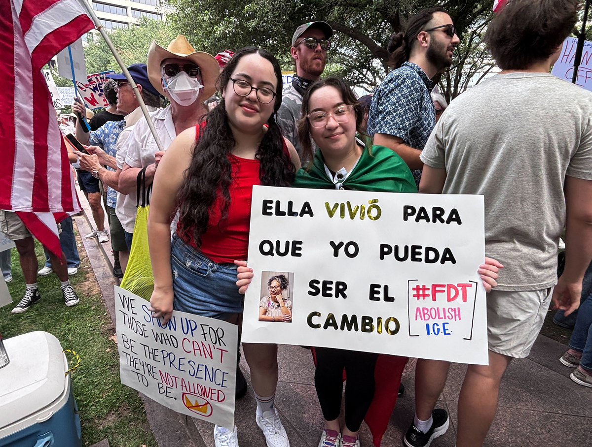 Ruth, left, and Katt Arreola hold a sign honoring their mother, who taught them to exercise their right to free assembly, at the “No Kings” protest in downtown Fort Worth on Saturday June, 14, 2025.