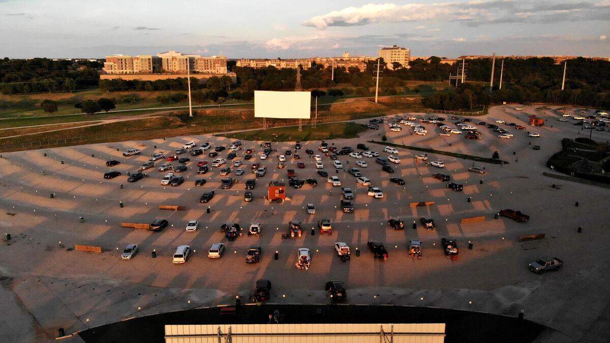 The sun sets as a movie begins at one of four screens at Coyote Drive-In movie theater. Ford and Marvel Studios partnered to screen “Thor: Love and Thunder” at the Fort Worth location.