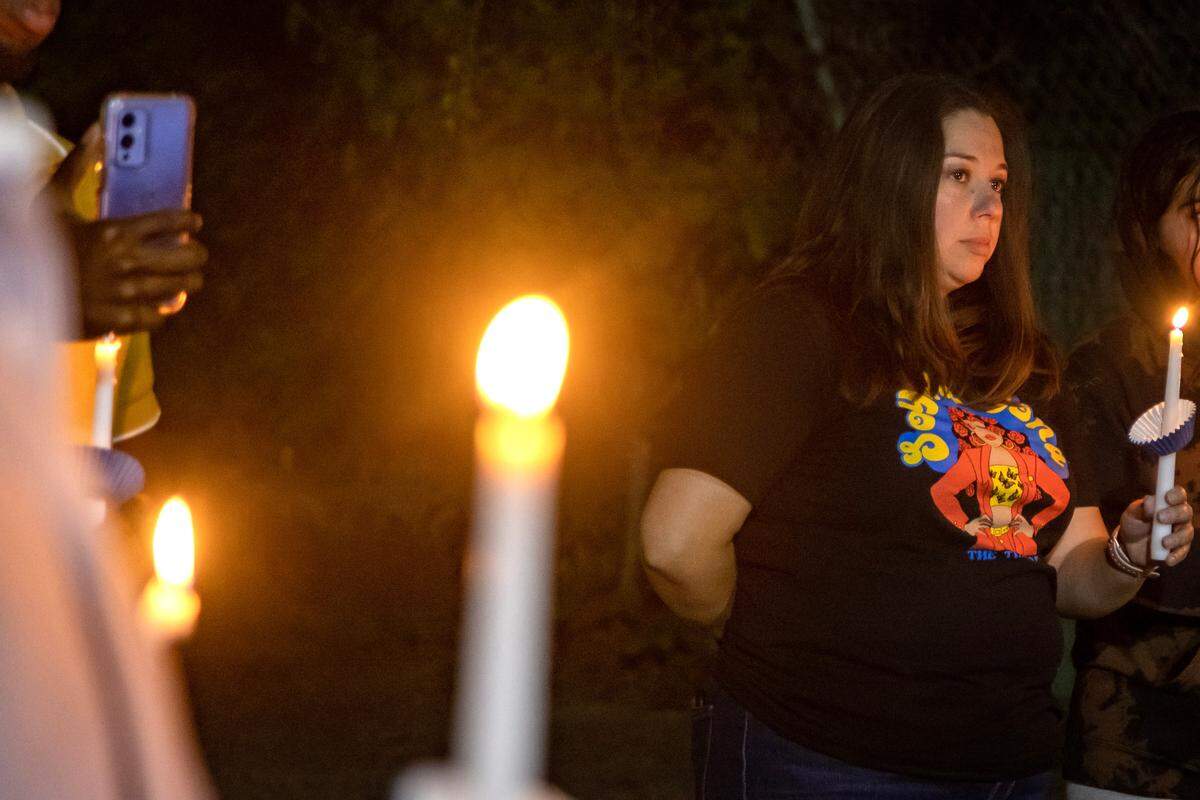 Tara Maldonado-Wilson holds a lit candle at the vigil she organized for Brandon Zapata on Friday, April 21, 2023, at the Southside Bar And Partyhall in Fort Worth. Zapata, 20, died after being restrained and handcuffed by an off-duty police officer at La Gran Plaza.