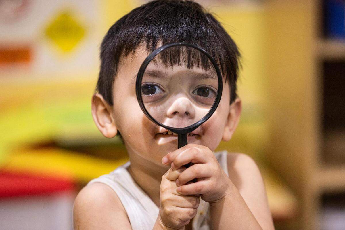 Student Carmine Arriago, 3, plays with a magnifying glass in the evening at the Future Scholars’ Childcare and Transportation child care home in Grand Prairie on Thursday, March 14, 2024. Future Scholars’ is one of few programs in Tarrant County that provide 24/7 child care.