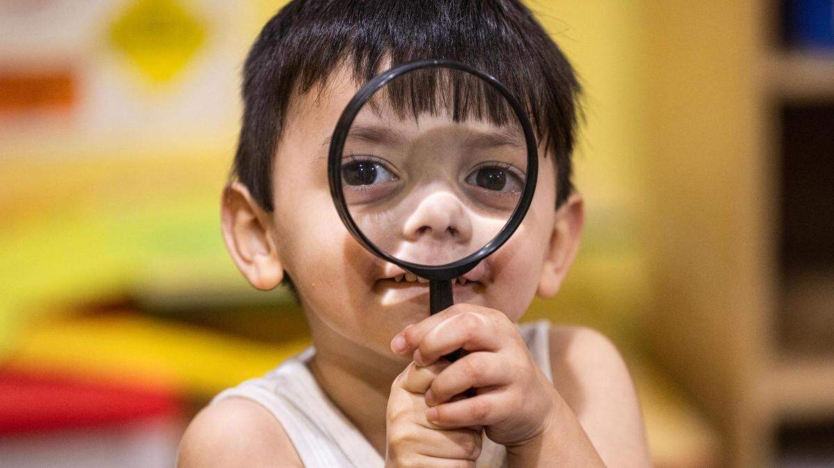Student Carmine Arriago, 3, plays with a magnifying glass in the evening at the Future Scholars’ Childcare and Transportation child care home in Grand Prairie on March 14. Future Scholars’ is one of few programs in Tarrant County that provide 24/7 child care.
