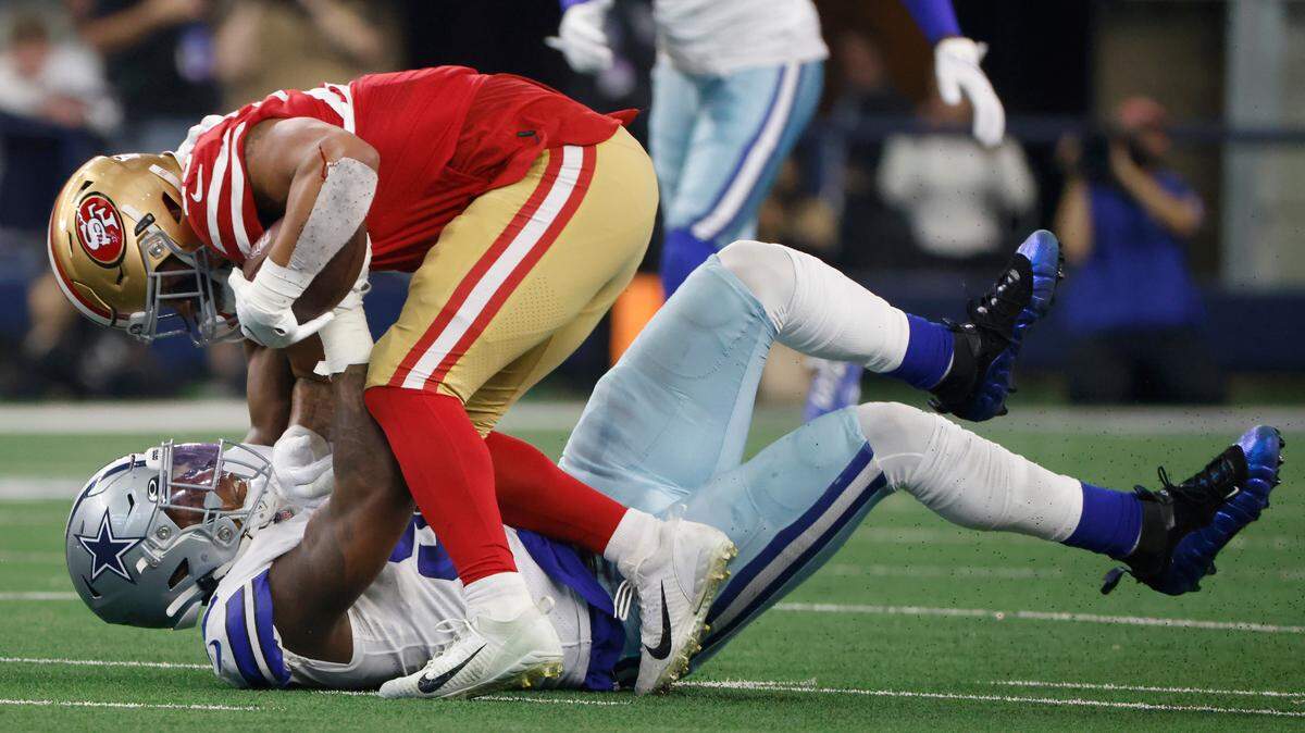 San Francisco 49ers running back Elijah Mitchell is tackled by Dallas Cowboys defensive end Dorance Armstrong during the first half Sunday. The Cowboys trailed the 49ers 16-7 at the half.