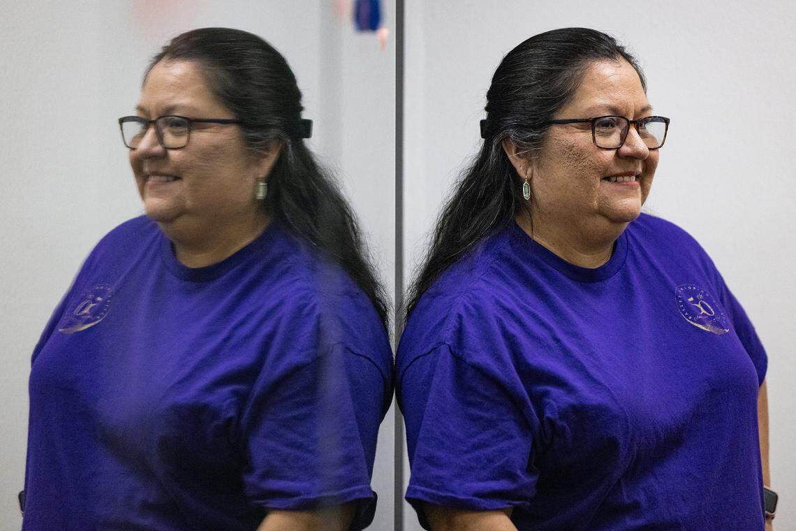 Carol Alvarado, the director of Ballet Folklorico Azteca de Fort Worth, smiles while reflected in the mirrors of the dance studio.