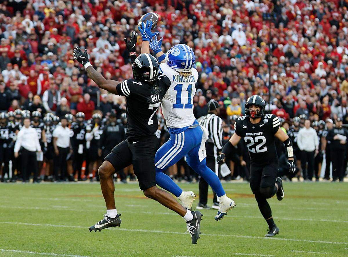 AMES, IA - OCTOBER 25: Wide receiver Parker Kingston #11 of the BYU Cougars pulls in a touchdown pass as defensive back Tre Bell #7 of the Iowa State Cyclones defends as linebacker John Klosterman #22 of the Iowa State Cyclones watches on in the second half of play at Jack Trice Stadium on October 25, 2025, in Ames, Iowa. The BYU Cougars won 41-27 over the Iowa State Cyclones. (Photo by David Purdy/Getty Images)