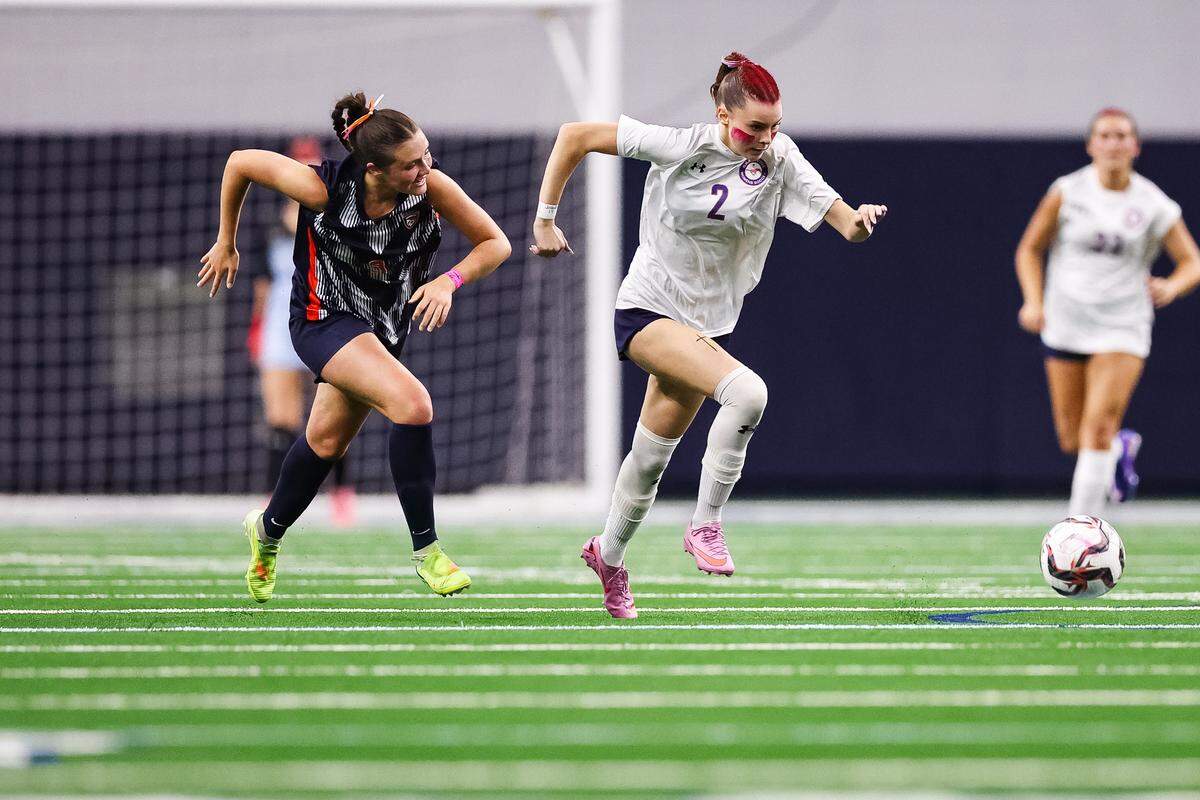 Grapevine forward Chloe O'Steen (2) dribbles past a Frisco Wakeland defender in a Class 5A Division II UIL girls soccer state semifinal at the Ford Center on April 3, 2026 in Frisco, Texas.