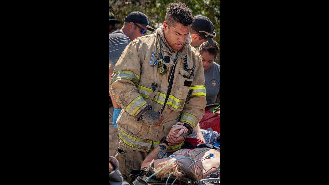 Fellow firefighters help Caleb Halvorson after he was pulled out from under a collapsed garage at the scene of a house fire on Wednesday, Sept. 3.