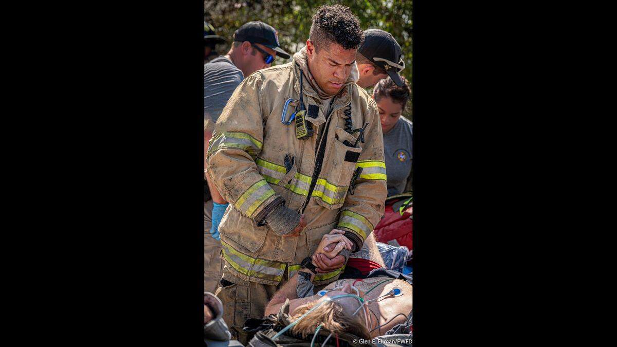 Fellow firefighters help Caleb Halvorson after he was pulled out from under a collapsed garage at the scene of a house fire on Wednesday, Sept. 3.