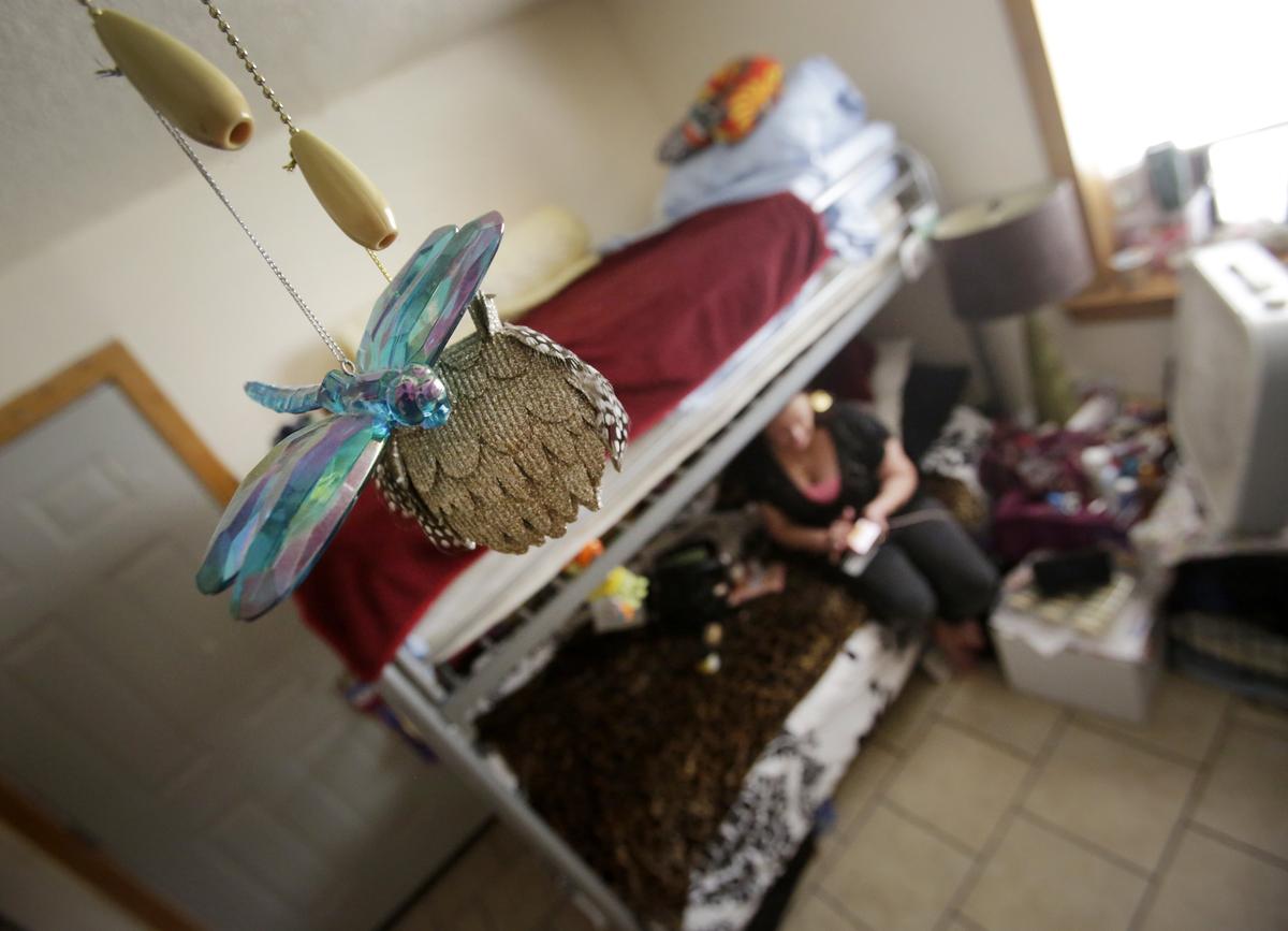 Resident Melinda S. checks the balance on a Walmart card in her room at Khadijah’s House in Fort Worth, Texas on Wednesday, Aug. 15, 2018.