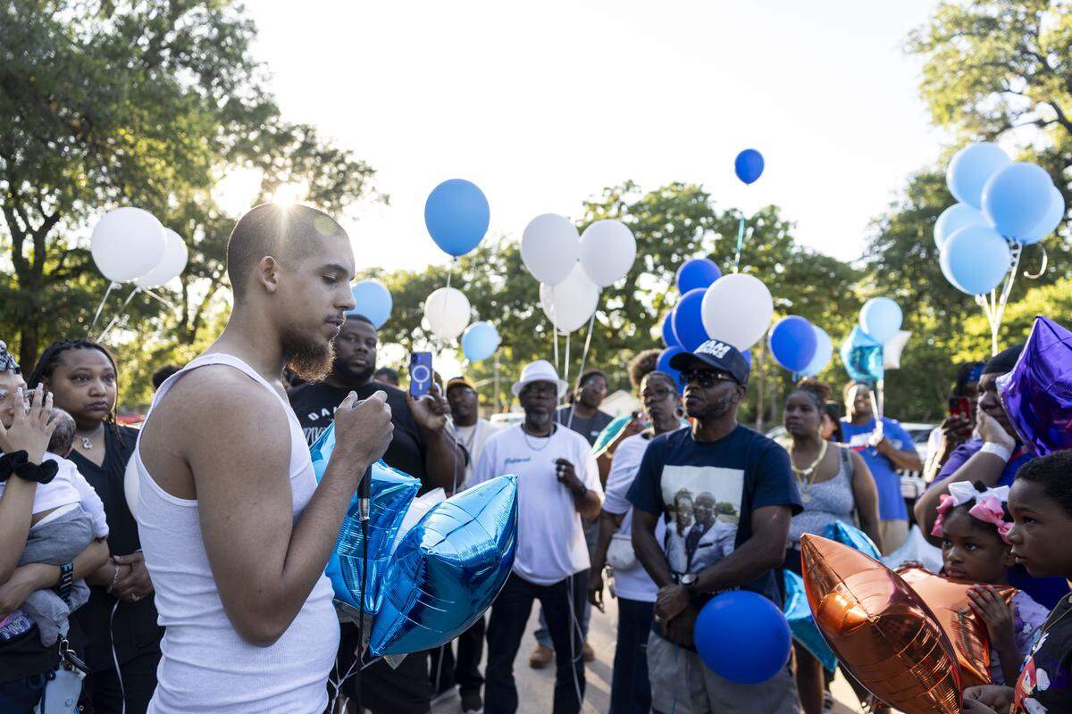 Wilson Tate, a cousin of Dominique Coleman, shares words in his honor during a vigil on Tuesday, May 12, 2026 in Fort Worth, Texas. Coleman, who was working as a security guard at Club New Start on Miller Avenue, was shot and killed early Sunday during an argument with customers outside the club.