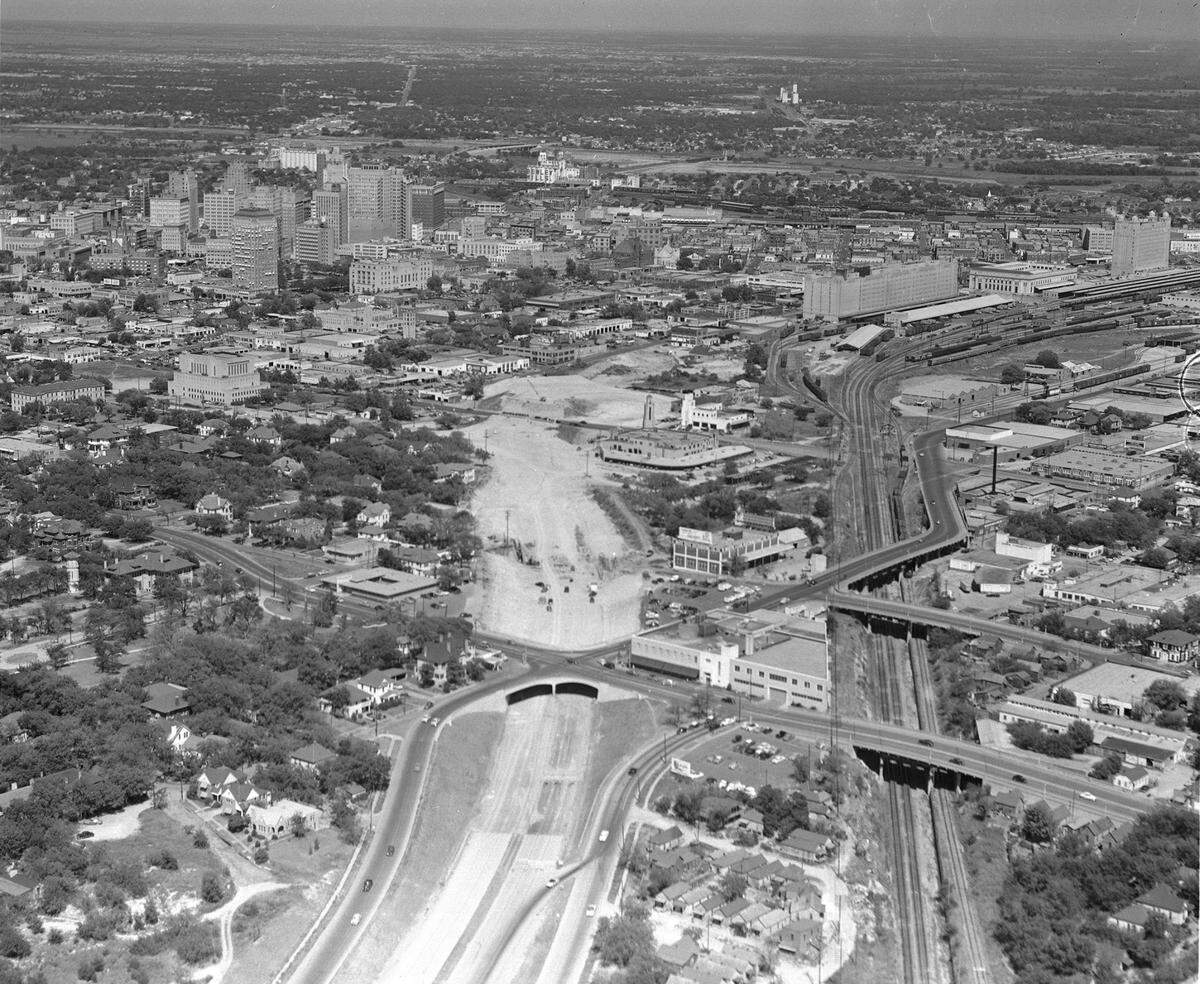 A 1953 aerial photograph of the East-West Freeway (I-30) under construction, with downtown and Lancaster’s monuments in the background. The state highway authority opened the Lancaster overpass in 1960.