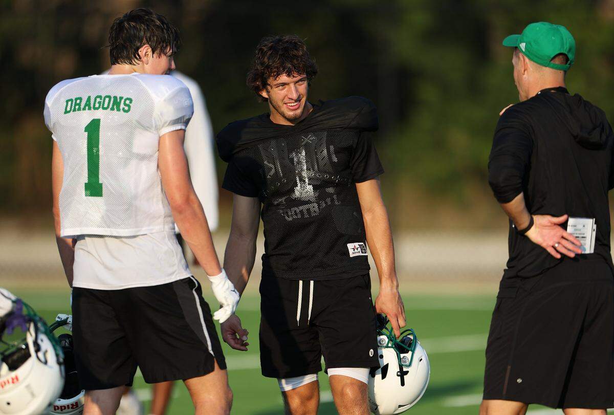Southlake Carroll quarterback Angelo Renda, center, takes a break during morning practice on Wednesday, Aug. 6, 2025, in Southlake.