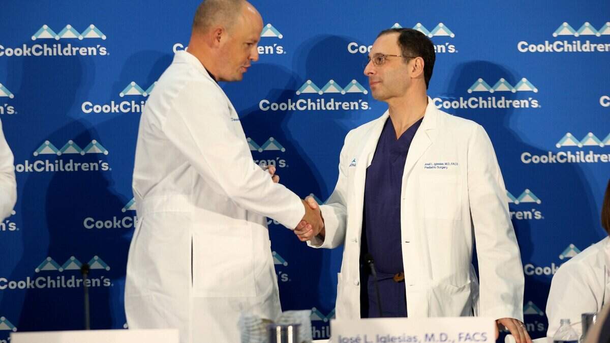Medical Director of Pediatric Surgery Jose L. Iglesias and pediatric surgeon Marty Knott shake hands after a press conference at Cook Children’s Medical Center in Fort Worth on Wednesday, Jan. 25, 2023. The pair and a large team of medical professionals successfully completed the first separation of conjoined twins, Amie and Jamie, for the first time in the hospital’s history.