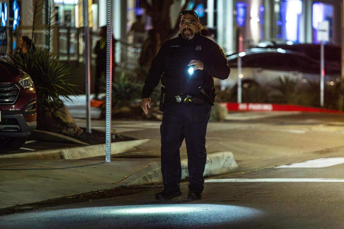 A Fort Worth Police Department officer shines his flashlight while supervising the crowds on Foch Street located in the West 7th District in Fort Worth on Friday, March 22, 2024. Out of a total of 3,197 crimes reported in Fort Worth’s entertainment districts from Jan. 1, 2023, to March 10, 2024, the largest number happened in the West 7th area, totaling 1,288.