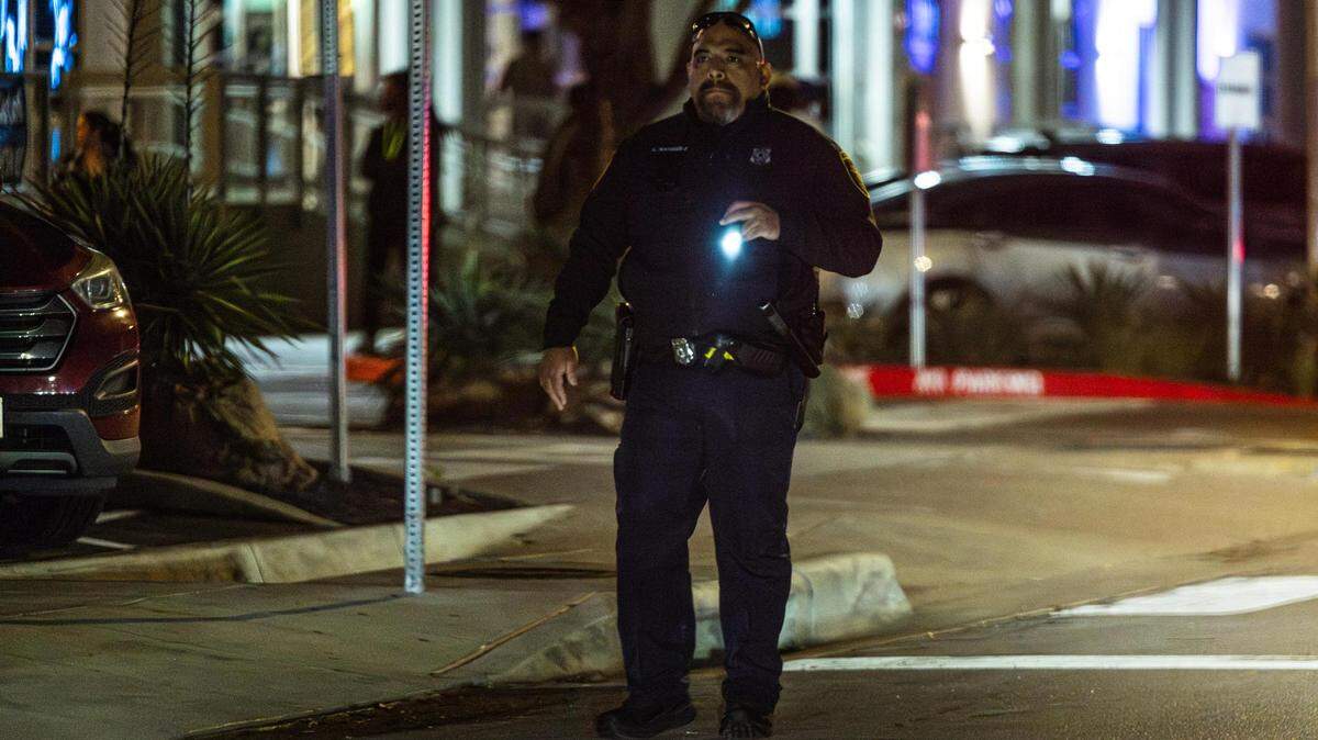 A Fort Worth Police Department officer shines his flashlight while supervising the crowds on Foch Street located at the West 7th Street District in Fort Worth on Friday, March 22, 2024. Out of a total of 3,197 crimes reported in Fort Worth’s entertainment districts from Jan. 1, 2023, to March 10, 2024, the largest number happened in the West 7th area, totaling 1,288.