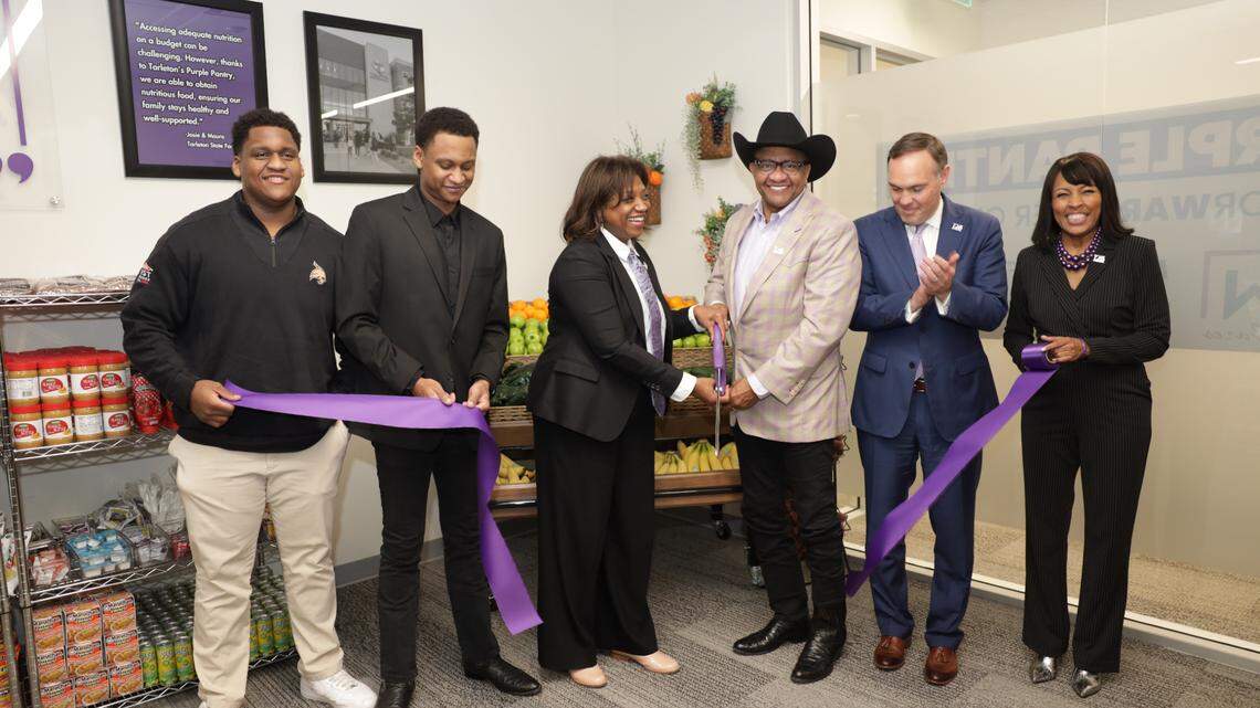 Mitchell Ward and Pam Wills-Ward, center, take part in the cutting ceremony for the Purple Pantry at The Purple Pantry at Tarleton State University’s Fort Worth campus on Jan. 29, 2025.