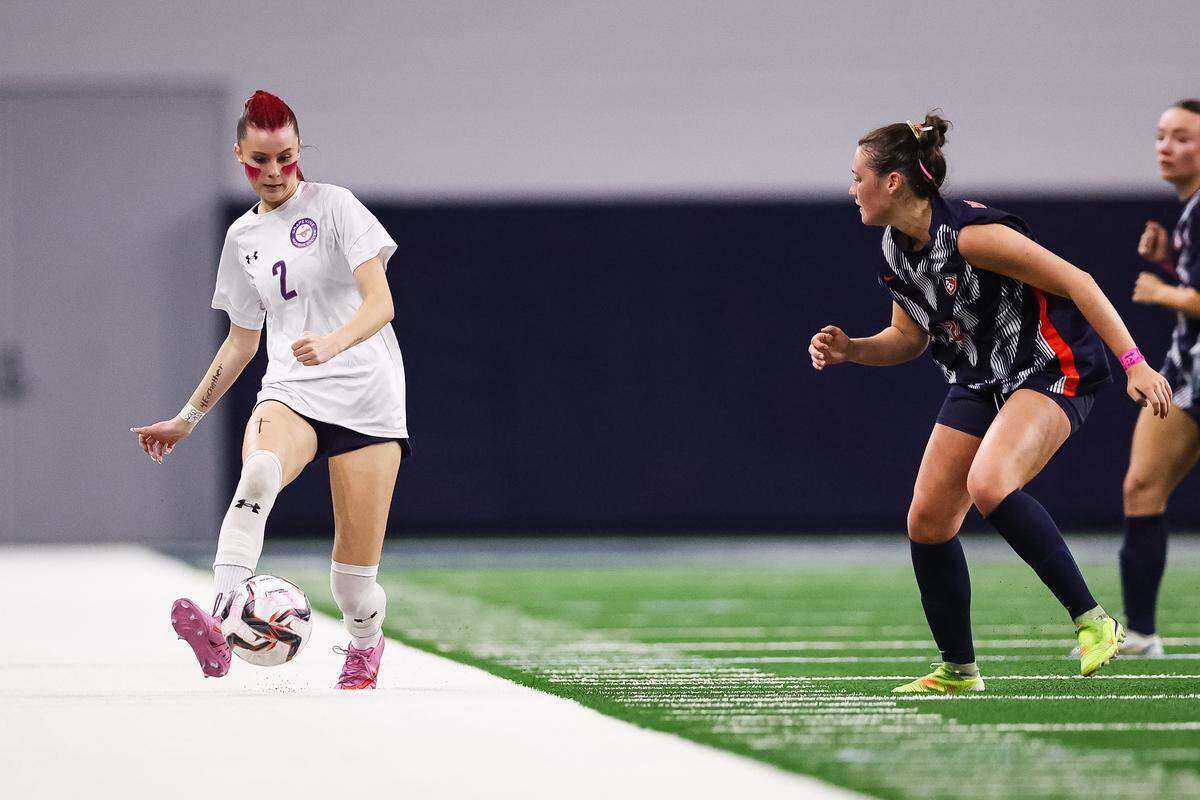 Grapevine forward Chloe O'Steen (2) attempts to make a pass against a Frisco Wakeland defender in a Class 5A Division II UIL girls soccer state semifinal at the Ford Center on April 3, 2026 in Frisco, Texas.