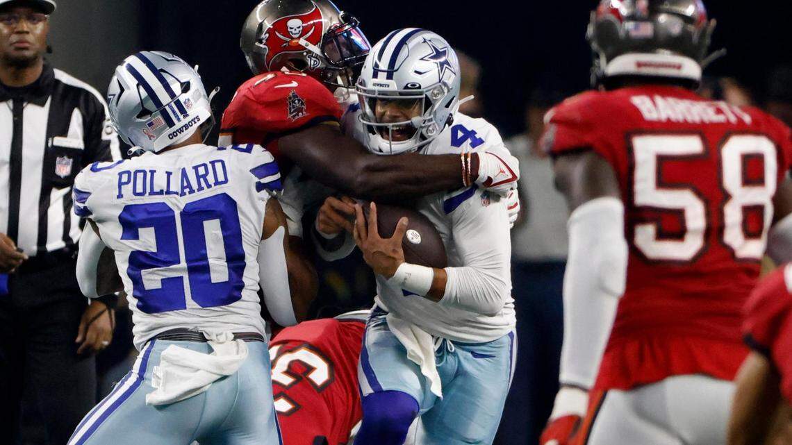 Tampa Bay Buccaneers’ Devin White, center left, sacks Dallas Cowboys quarterback Dak Prescott (4) as running back Tony Pollard (20) and linebacker Shaquil Barrett (58) look on in the second half of a NFL football game in Arlington, Texas, Sunday, Sept. 11, 2022. (AP Photo/Ron Jenkins)