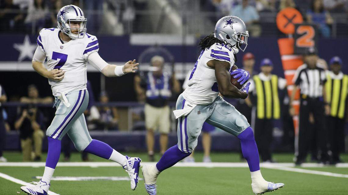Cowboys quarterback Cooper Rush, left, hands off to running back Bo Scarbrough in a preseason game against the Cardinals. Scarbrough has rushed for 52 yards and a touchdown on 20 carries in three games.