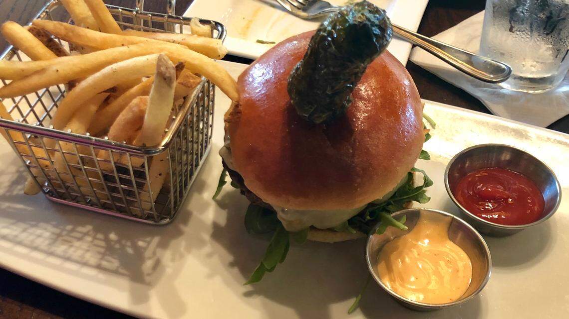 The “Texas Heat” burger at Troy’s in Texas Live! features fried jalapenos and onions, pepper Jack cheese, Sriracha mayo, chipotle-garlic ketchup and a seared jalapeno on top.