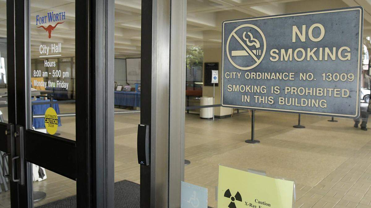 A no smoking sign hanging outside of City Hall. in 2017