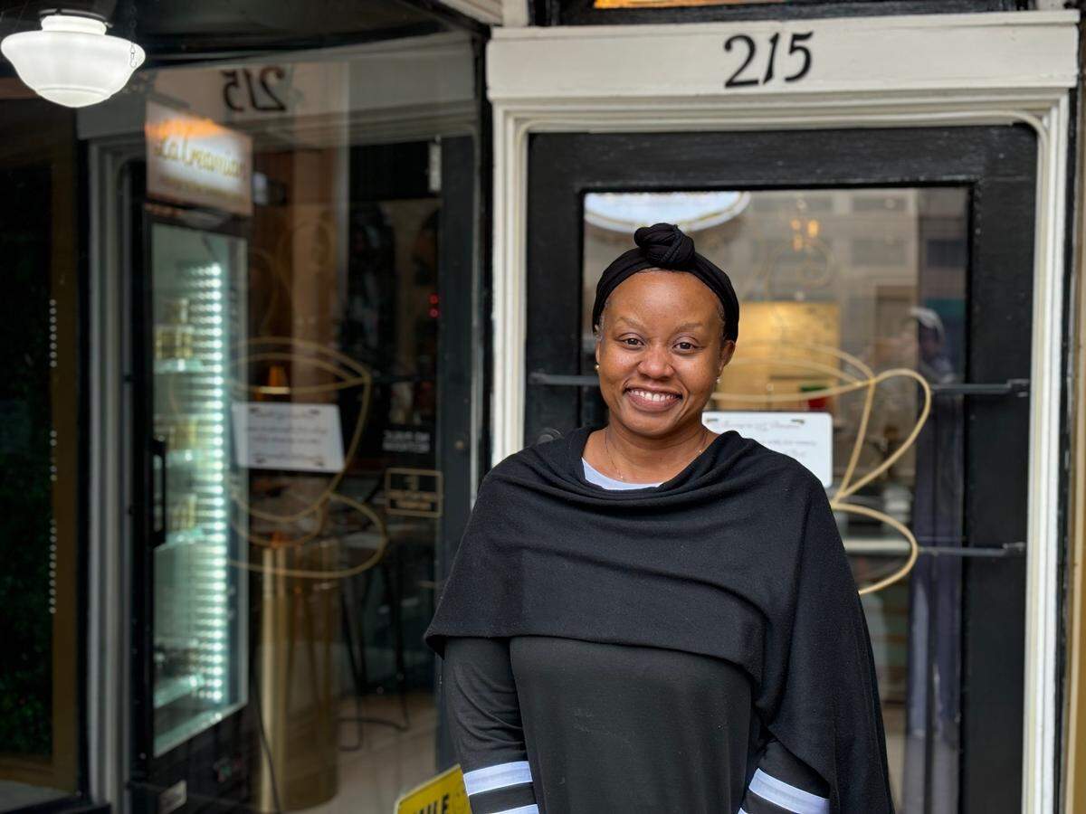 La’Cremian owner Lisa Jackson poses for a photo outsite of the ice cream and coffee shop she opened on West 8th Street just eight months before the Sandman Signature Hotel explosion changed the outlook of the future of her business.