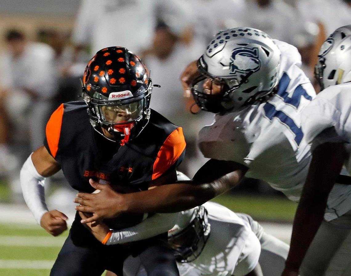 Shoemaker defensive end Zavian Tibbs (15) reaches in for Aledo running back Hawk Patrick-Daniels (1) in the first half of a Class 5A D1 bi-district football game between Killeen Shoemaker and Aledo at Bearcat Stadium in Aledo, Texas, Thursday, Nov. 10, 2022. Aledo led Shoemaker 28-0 at the half. (Special to the Star-Telegram Bob Booth)