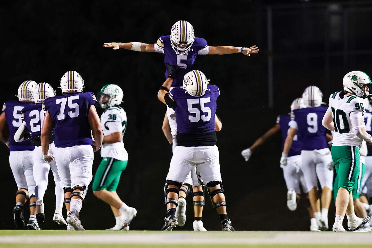 Keller Timber Creek quarterback Lane Brinkley (5) gets lifted in the air by his teammate Damian Perez (55) after passing for a touchdown against Southlake Carroll during a district matchup on Thursday, September 25, 2025 at Keller ISD Stadium in Keller, Texas.