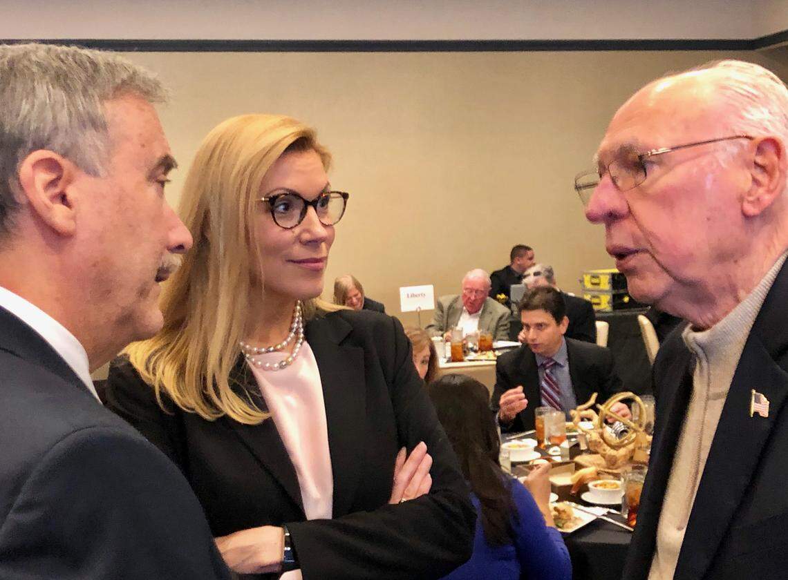 At a Dallas luncheon Nov. 13, Pastor Rafael B. Cruz, right, the father of U.S. Sen. Ted Cruz, talks with University of Virginia political scientist Larry Sabato and regional administrator Beth Van Duyne of the federal Housing and Urban Development Department.