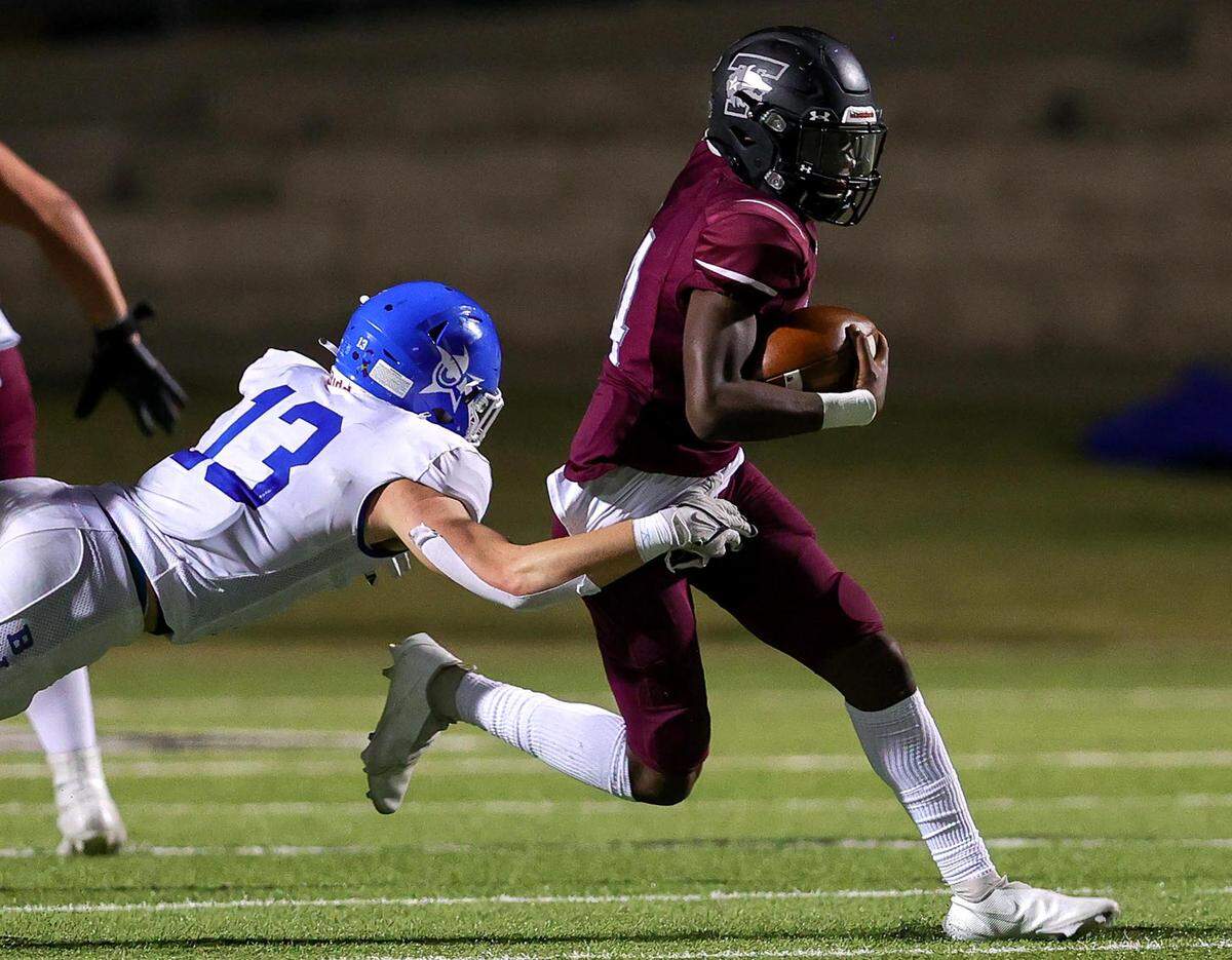 Mansfield Timberview quarterback Cameron Bates (r) tries to scramble past Joshua defensive back Drew DeArman (13) during the first half, Thursday night, September 23, 2021 played at Newsom Stadium in Mansfield, TX. (Steve Nurenberg Special to the Star-Telegram)