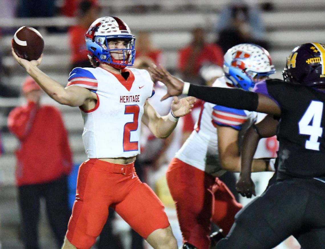Midlothian Heritage quarterback Kaden Brown, left, throws down the field for a completion as Everman’s Cortez Dunigan defends in the third quarter of Thursday’s November 4, 2022, District 5-5A Division 2 football game at Marr Stadium in Everman, Texas. Heritage went on to win 35-34. Special/Bob Haynes