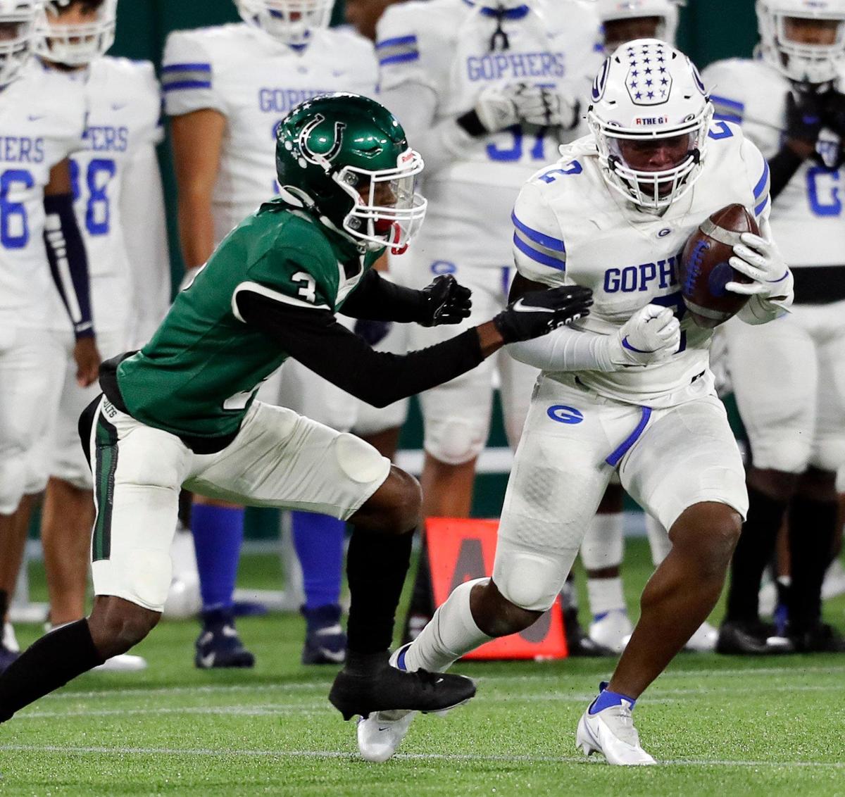 Arlington defensive back Lesley Odimara (3) grabs Grand Prairie wide receiver Savion Red (2) after a catch during a high school football game at Globe Life Park in Arlington Texas, Friday, Oct. 23, 2020. The Colts defeated the Gophers 35-10. (Special to the Star-Telegram Bob Booth)