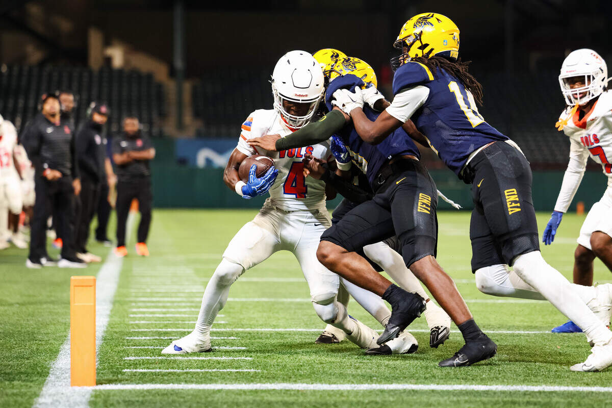A group of Arlington Lamar defenders attempt to bring down Arlington Bowie wide receiver Keidric Osunde-Brown (4) while he attempts to run toward the end zone in a district match up at Choctaw Stadium in Arlington, Texas on October 30, 2025.