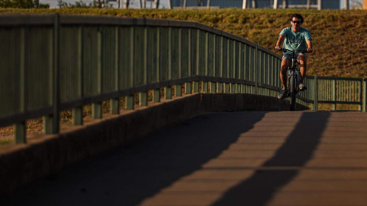 Will Jeffery endures the heat on a bike ride on the Fort Worth Branch Bridge at Panther Island Pavilion in Fort Worth on July 13.