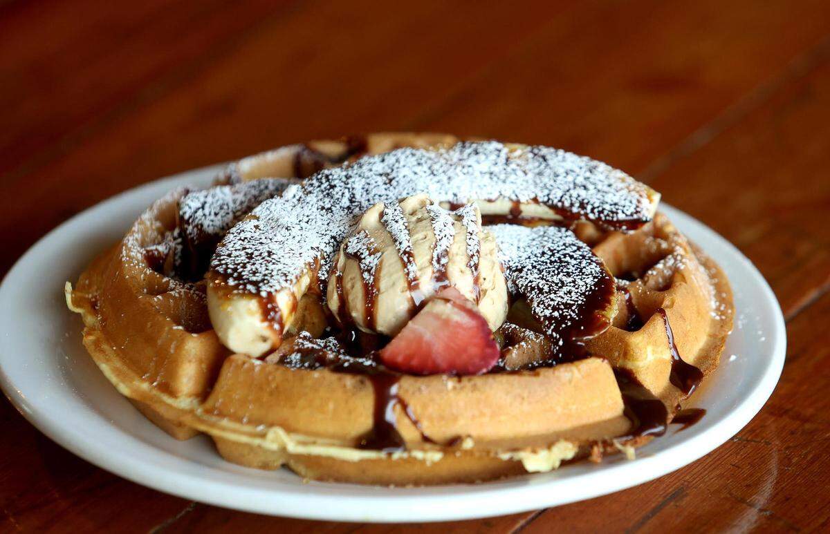 The bacon banana Belgian waffle at Brewed features a housemate Belgian waffle with caramelized banana, espresso whip cream and Nutella.