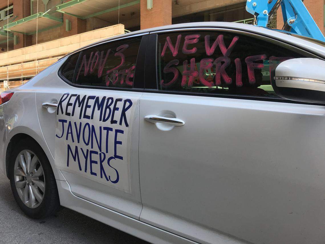 A driver moves with a caravan of other vehicles outside of the Tarrant County Jail on Saturday to protest recent deaths and conditions at the jail. Javonte Myers, whose name appears on this car, died in the jail of an unknown medical emergency, officials said.