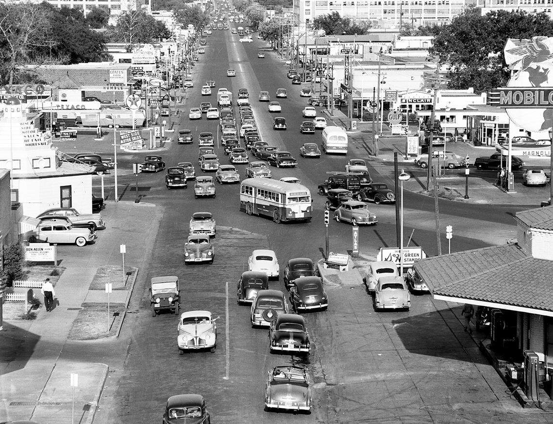 Captioned “traffic jitters,” this 1951 image looks straight ahead at the heavy approaching traffic. Gas stations were plentiful, and the buildings feel much closer to the streets than they do today.