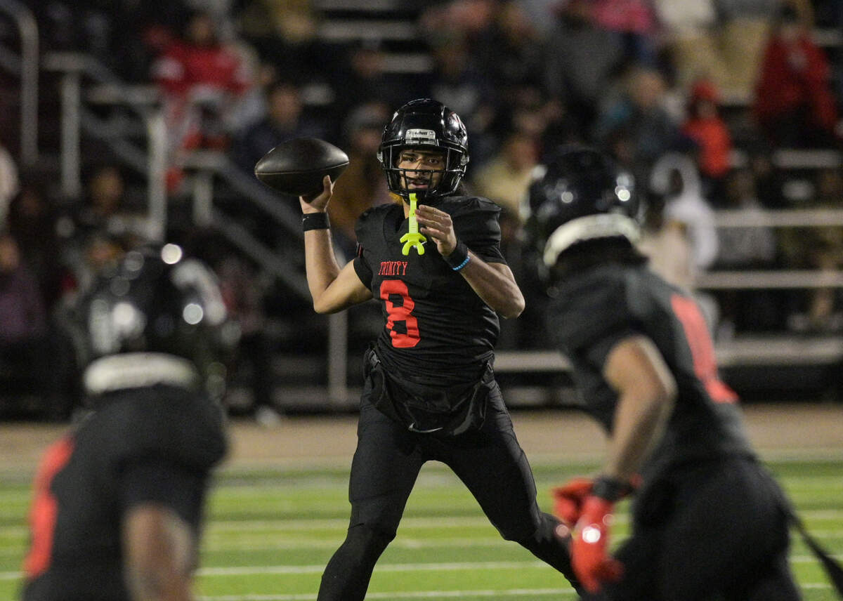 Trinity quarterback Tj Tupou (8) looks down the field for a pass during a UIL football playoff game against Allen High School at Dragon Stadium in Southlake, Texas on Friday, Nov. 29, 2024.