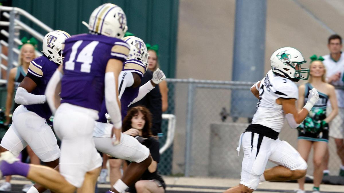 Carroll running back Davis Penn (3) races down the side lines for a Dragon touchdown in the first half of a UIL high school football game at Keller ISD Stadium in Keller on Sept. 14.