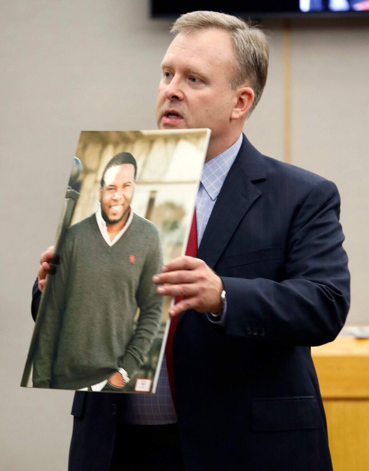 Assistant District Attorney Jason Hermus shows a photo of Botham Jean to the jury during his opening statement in former Dallas police Officer Amber Guyger’s trial in Dallas, Monday, Sept. 23, 2019. Guyger is accused of shooting Jean, her neighbor, in his Dallas apartment. (Tom Fox/The Dallas Morning News via AP, Pool)