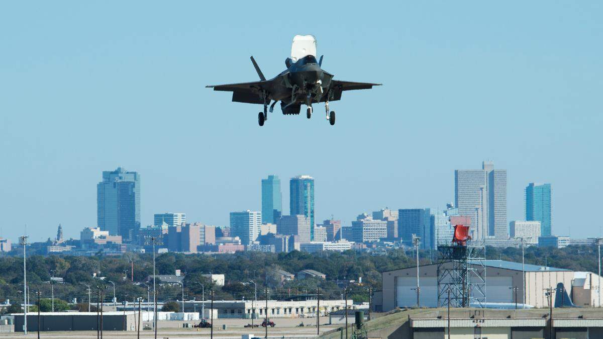 A F-35B fighter, designed for the Marines, hovers over the Lockheed Martin Aeronautics in west Fort Worth, Wednesday, November 19, 2014 in a test flight after assembly at the plant.