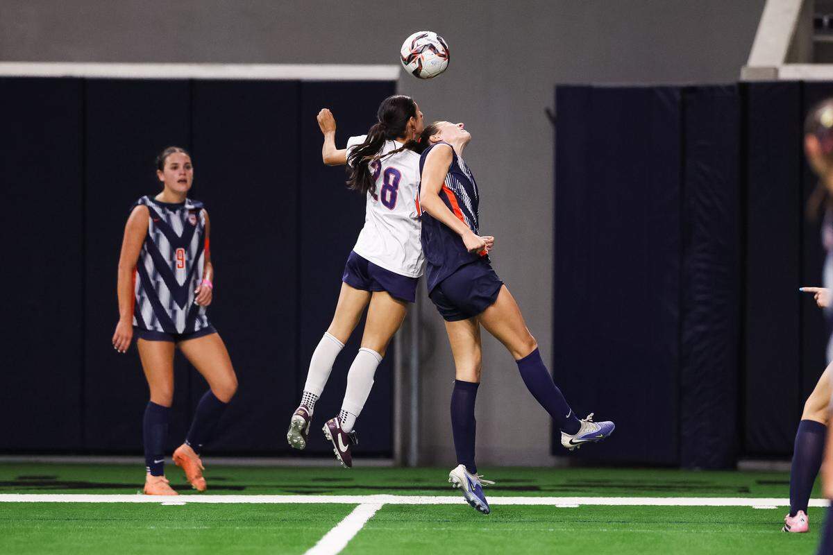 Grapevine forward Paola Granados (28) leaps in the air for the ball with a Frisco Wakeland defender in a Class 5A Division II UIL girls soccer state semifinal at the Ford Center on April 3, 2026 in Frisco, Texas.